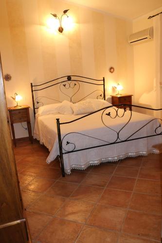 a bedroom with a bed and two night tables at B&B Le Foglie D'Argento in Caltabellotta