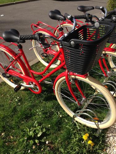 a group of red bikes parked on the grass at Best Western Plus Paris Velizy in Vélizy-Villacoublay