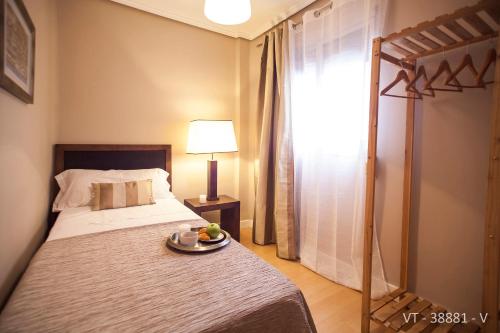 a bedroom with a bed with a plate of fruit on it at Alcam Arte Ciencia in Valencia