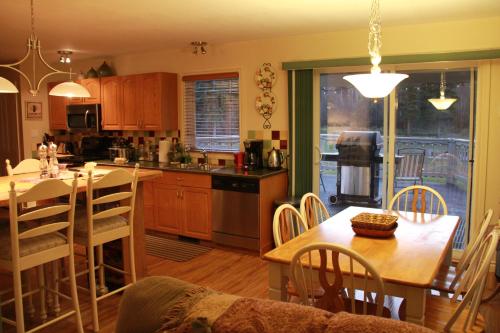 a kitchen with a table and a dining room at Bear Paw Lodge in Golden
