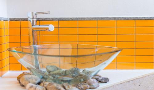 a glass bowl sitting on a counter next to a sink at Villa Patmos Netia in Patmos