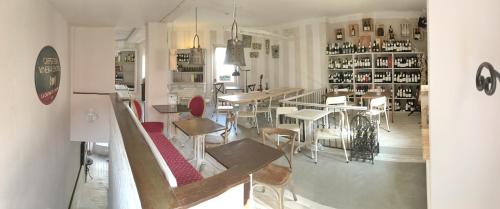 a restaurant with tables and chairs in a room at Cantina del Convento Maison in Chieri
