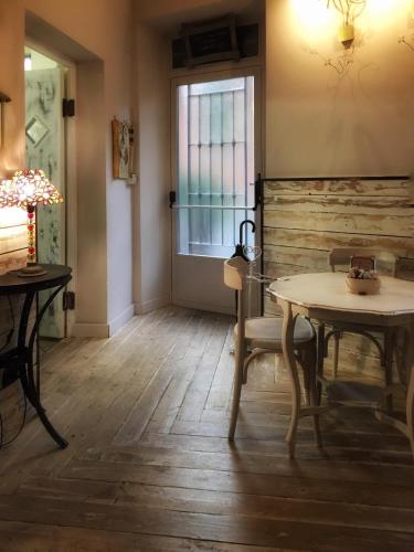a dining room with two tables and a window at Cantina del Convento Maison in Chieri