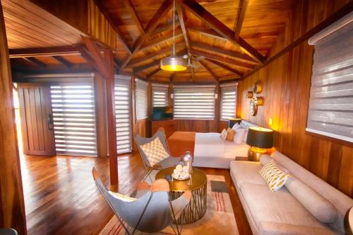 a living room with a couch and a table at Lucero Golf and Country Club Tree Houses in Boquete