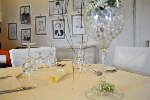 a table with wine glasses on top of it at Hotel Villa Fiorita in Sorrento