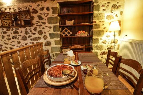 a wooden table with a pizza on top of it at Εν Αρχή - En Arhi in Ano Trikala