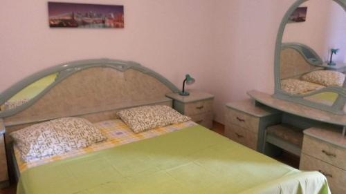 a bedroom with a bed with two mirrors on the wall at Apartments Uvala Murtar in Jezera