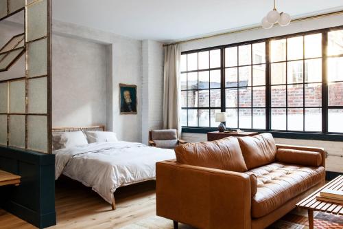 a bedroom with a bed and a couch at Lokal Hotel Old City in Philadelphia