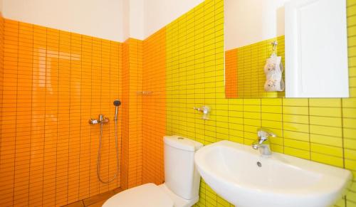 a bathroom with a toilet and a sink at Villa Patmos Netia in Patmos