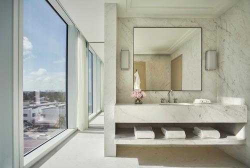 a bathroom with a sink and a mirror at Four Seasons Hotel at The Surf Club in Miami Beach