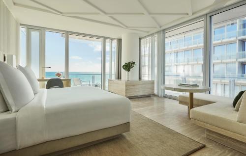 a bedroom with a bed and a view of the ocean at Four Seasons Hotel at The Surf Club in Miami Beach
