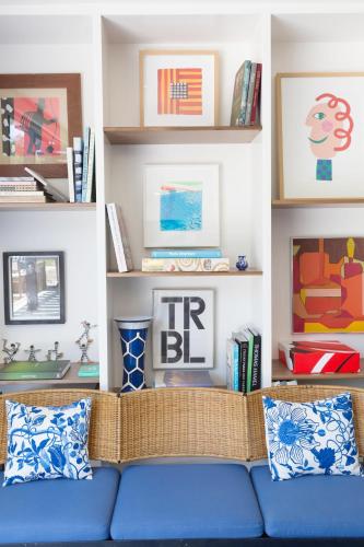 a living room with a blue couch and shelves at Holiday House Palm Springs in Palm Springs