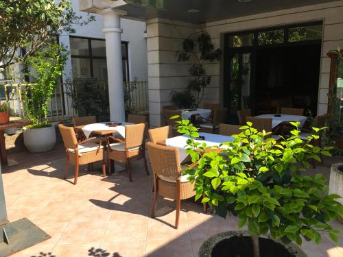 a patio with tables and chairs on a patio at Villa Royal Apartments in Tivat