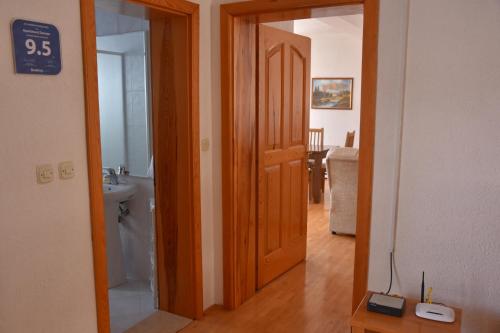 a hallway with a door leading to a bathroom at Apartment and Studio Damjan in Ohrid