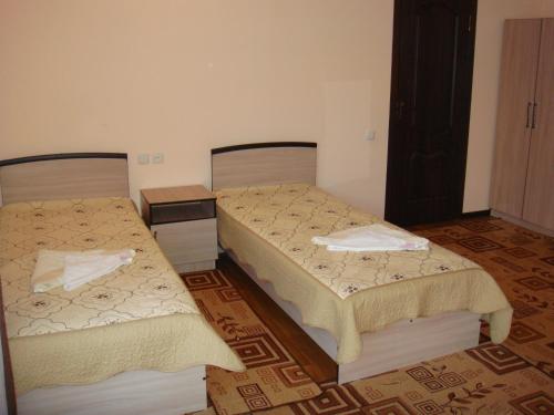 a room with two beds in a room at Mini-pansionat Maksat in Cholpon-Ata