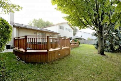 a house with a large wooden deck in a yard at Quiet and Comfortable Homestay in Oakville