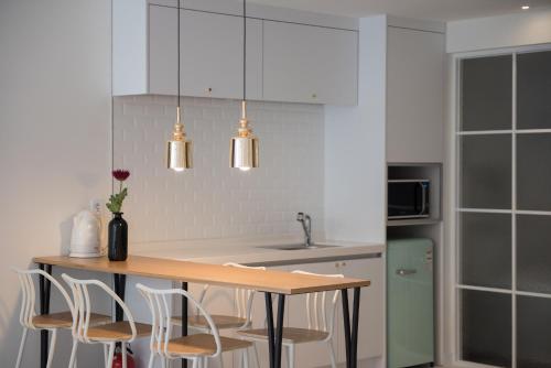 a kitchen with a wooden table and chairs at Boutique Hotel XYM Pyeongtaek in Pyeongtaek
