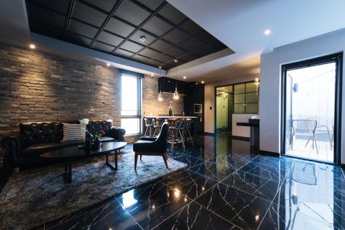 a living room with a couch and a table at Boutique Hotel XYM Pyeongtaek in Pyeongtaek