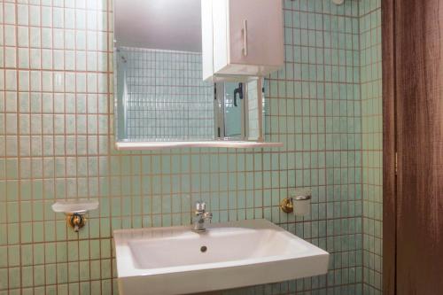 a bathroom with a sink and a mirror at Lak Peristeri Homes 50m from metro station in Athens