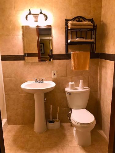 a bathroom with a toilet and a sink at Buoy 16 Motel by the Beach in Seaside Heights