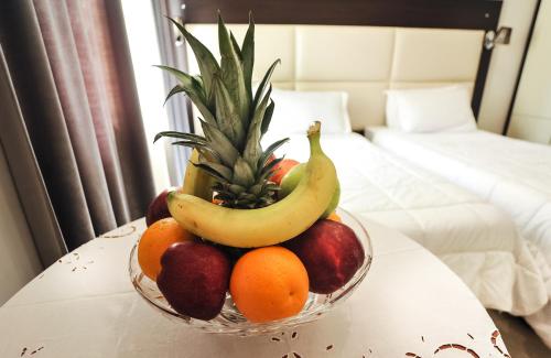 a bowl of fruit on a table in a hotel room at Hotel Vila e Arte City Center in Tirana