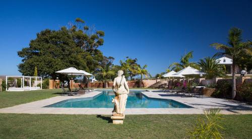 a statue of a woman standing next to a pool at White Water Farm in Stanford