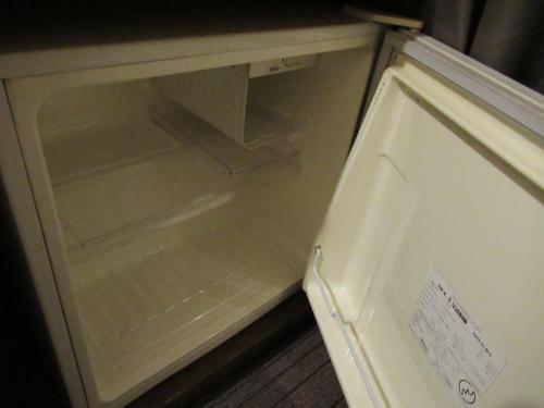 an empty refrigerator with its door open in a room at Hotel Crown Hills Kumamoto in Kumamoto