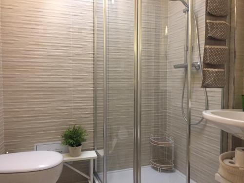 a bathroom with a shower and a toilet and a sink at Donna Isabella in Trani