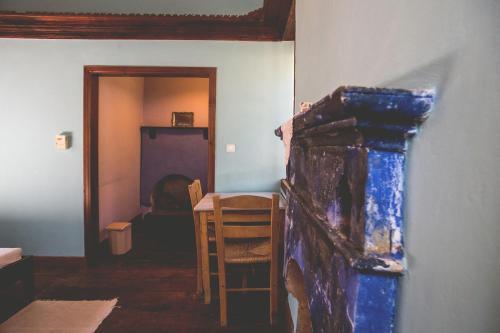 a room with a table and a chair and a fireplace at Karnayo in Meyisti
