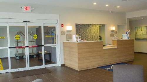 a room with a store with glass doors and a counter at Microtel Inn & Suites by Wyndham - Penn Yan in Penn Yan