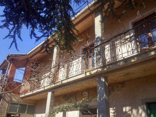 a building with a balcony on the side of it at Zia Chiarina in San Nicolò Gerrei