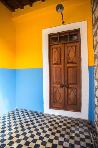 a door in a room with a checkered floor at Karnayo in Meyisti