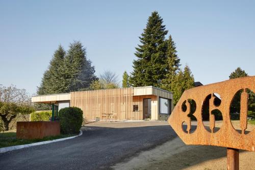a building with a sign in front of it at WURZENBERG Hotel Lodges Südsteiermark in Gamlitz