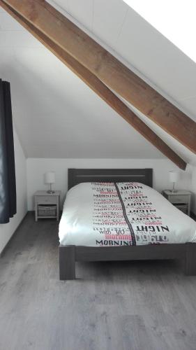 a bedroom with a bed and two end tables at L'Auréthan in Vielsalm