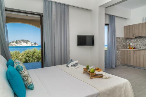 a bedroom with a large bed with a view of the ocean at Arba Rooms in Marathias