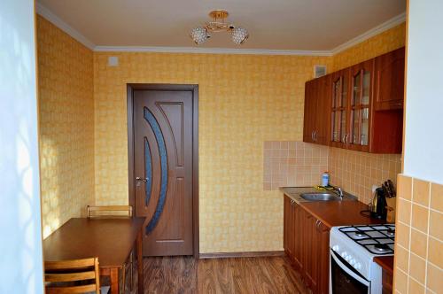 a kitchen with a door and a sink and a stove at Central Park Apartment on Pushkin 33 in Chişinău