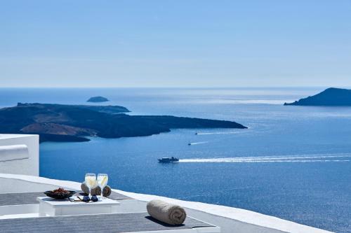 a view of the ocean with a boat in the water at Nautilus Villa in Firostefani