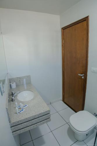 a bathroom with a sink and a toilet at Hotel Dom Thomaz in Jaguariaíva