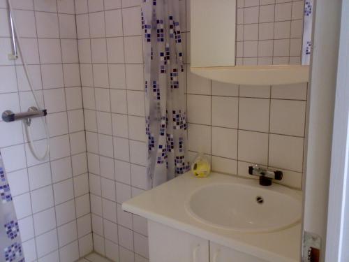 a white bathroom with a sink and a shower at Hotel Gedser Apartments in Gedser