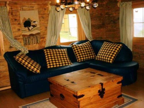 a living room with a blue couch and a coffee table at Lindlhof Fam. Taferner in Sankt Andrä