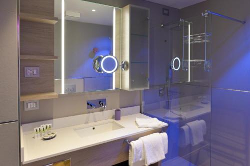 a bathroom with a sink and a shower at Aktivhotel Santalucia in Nago-Torbole