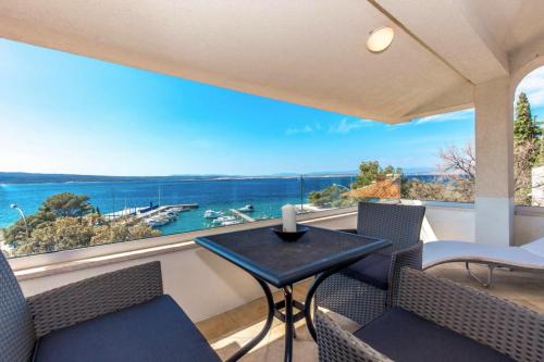 a balcony with a table and chairs and a view of the ocean at Apartments Sax in Crikvenica