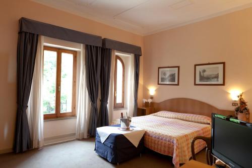 Кровать или кровати в номере Hotel Porziuncola