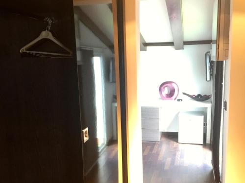 an open door to a room with a kitchen and a hallway at Hotel Nereida in L'Estartit