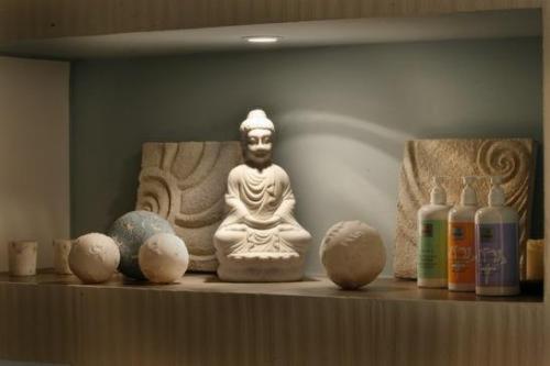 a shelf with a statue of a buddha on it at Hotel & SPA Waldecker Hof in Willingen