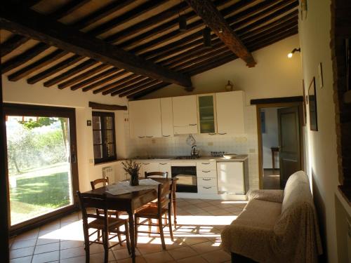 a kitchen and dining room with a table and chairs at Agriturismo La Fraternita in Montepulciano