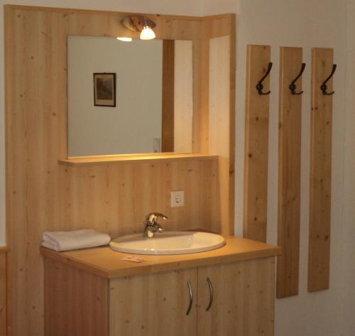 a bathroom with a sink and a mirror at Apartmenthaus Gotthardt in Kaprun