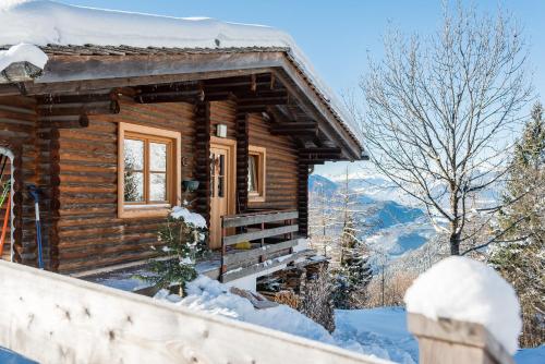 a log cabin in the mountains in the snow at Ropferhof in Telfs-Buchen