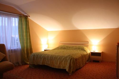 a hotel room with a bed and a window at Hotel Mare & Restaurant in Roja