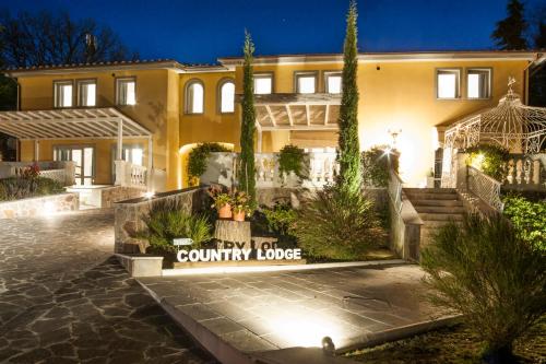 a house with a country lodge sign in front of it at Country Lodge B&B in Siena